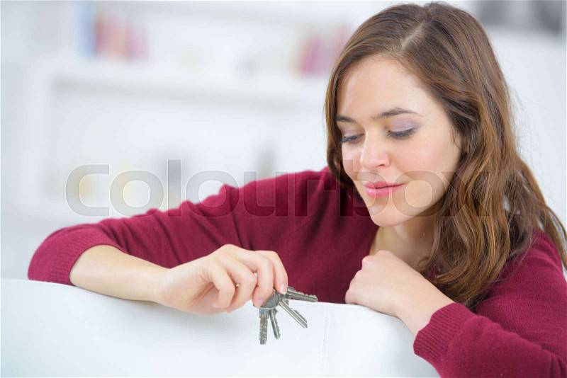 Happy apartment owner showing keys, stock photo
