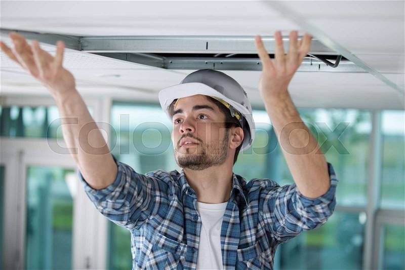 Carpenter at work with roof construction, stock photo