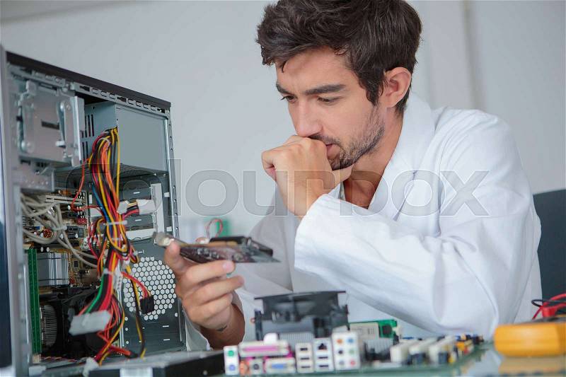 Computer engineer working on broken console, stock photo