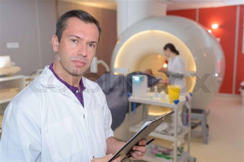 Doctor with patient doing cat scan with ct scanner, stock photo