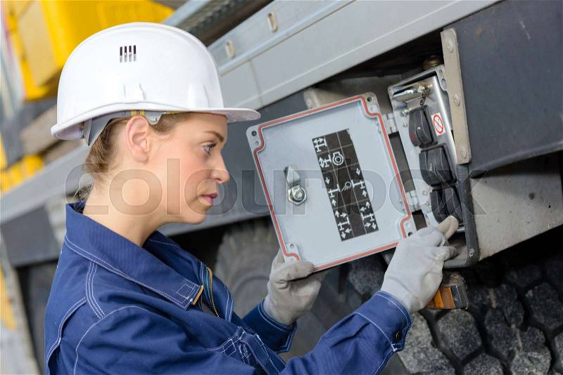 Woman electrician engineer inspecting electric counter utdoors, stock photo