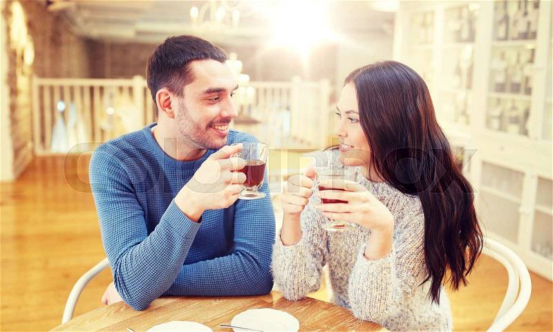 People, communication and dating concept - happy couple drinking tea at cafe or restaurant, stock photo