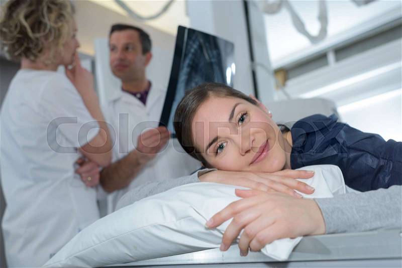 Happy patient smiling at camera in medical office, stock photo