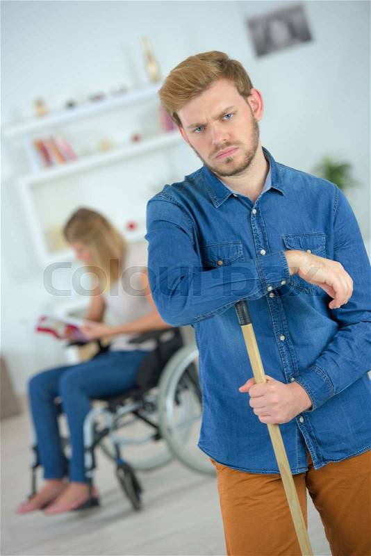 Man tired after cleaning house, stock photo
