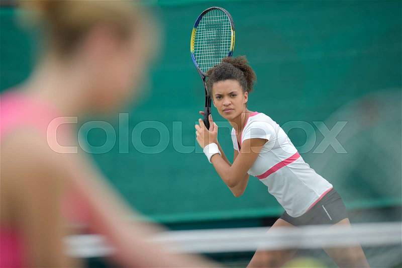 Tennis female player ready to serve on clay court outdoor, stock photo