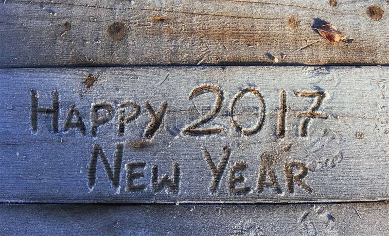 Writing on the snow. Wooden texture. On a wooden board. Happy New Year, stock photo