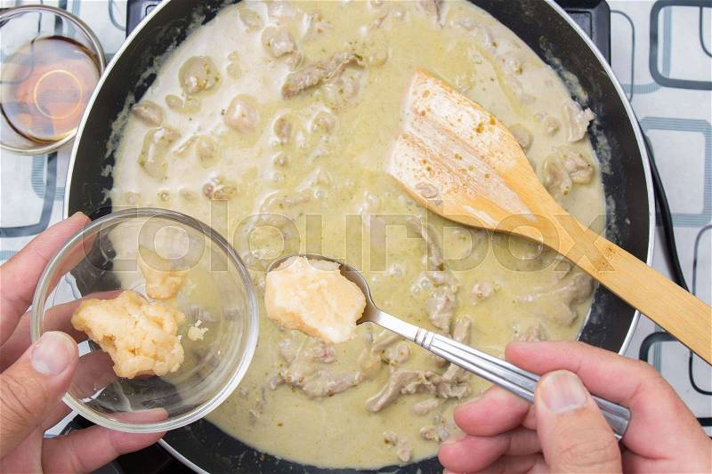 Chef putting cooconut palm sugar for cooking green curry / cooking green curry concept, stock photo
