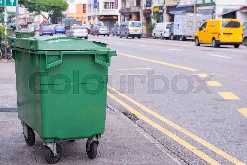 Green recycling bin container or garbage Trashcan on the street of city, stock photo