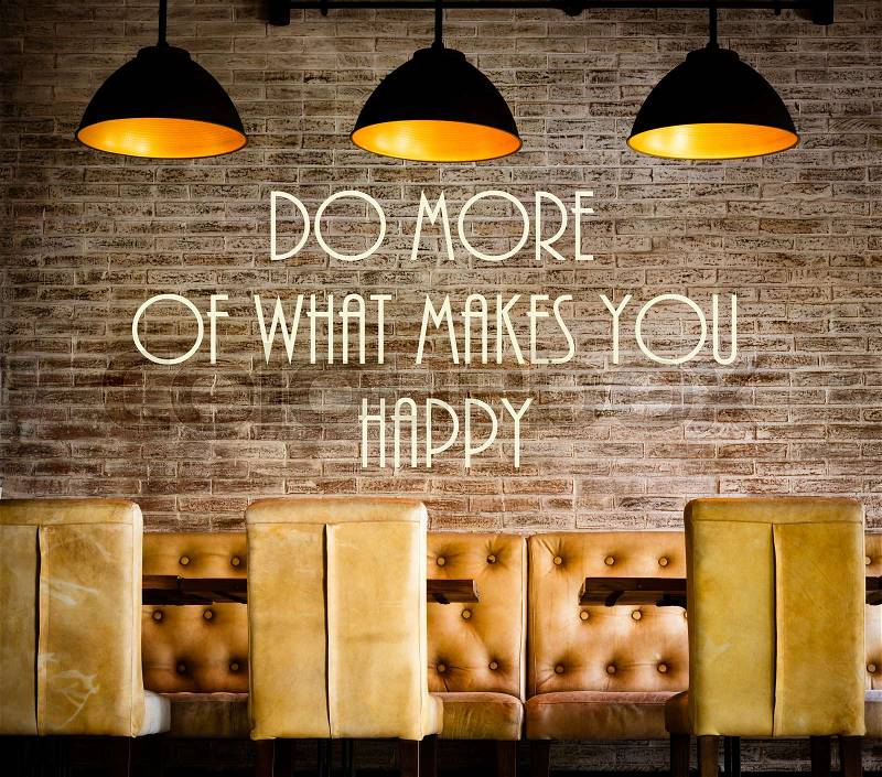 Do More Of What Makes You Happy motivational message written on vintage brick wall, stock photo