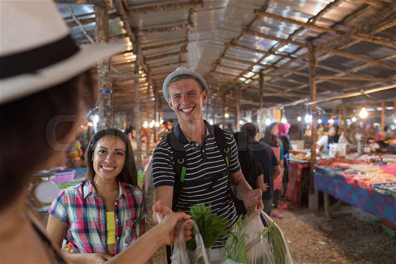Tourists On Tropical Street Market In Thailand Young People Buying Fresh Fruits And Vegetables On Asian Bazaar, stock photo