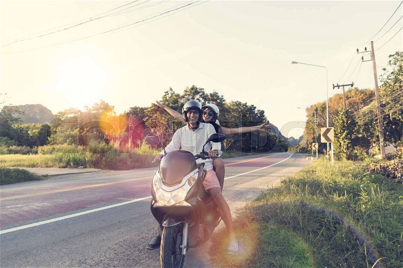 Happy Couple Riding Motorcycle In Countryside Excited Woman And Man Travel On Motorbike Summer Road Trip Concept, stock photo