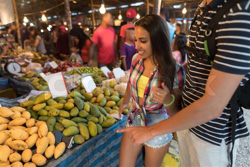 Tourists On Tropical Exotic Market Young People Buying Fresh Fruits In Asian Traditional Bazaar, stock photo