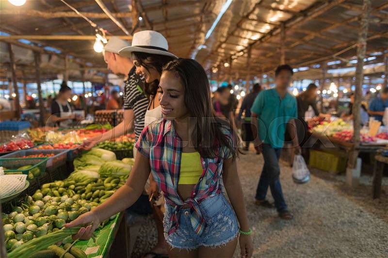 Tourists Choosing Vegetables On Traditional Asian Market Young People Buying Products In Street Exotic Bazaar, stock photo