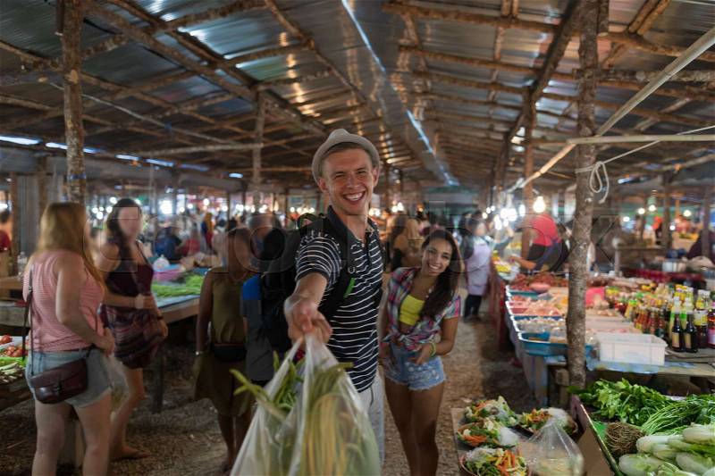 Happy Smiling Couple Hold Bags With Vegetables In Street Market Cheerful Man And Woman Shopping Together On Traditional Exotic Bazaar, stock photo