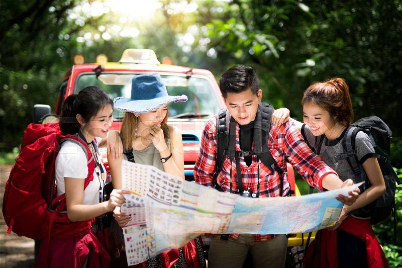 Asian couple lost and miss may, they try to check a map for escept from rainforest, stock photo