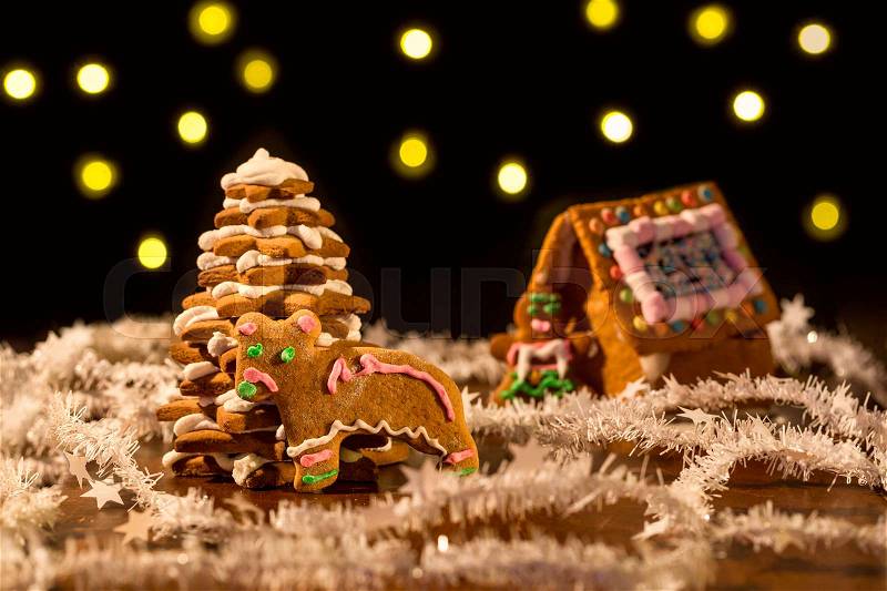 Christmas gingerbread tree and house with lights on background, stock photo
