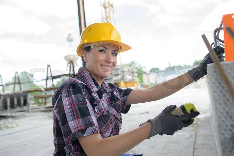 Female construction engineer in construction area, stock photo