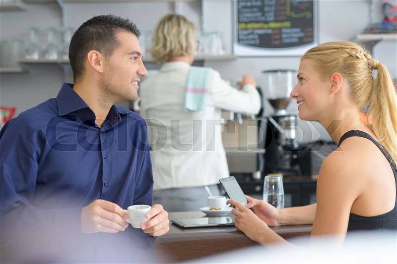 Two young people talking in the cafe, stock photo