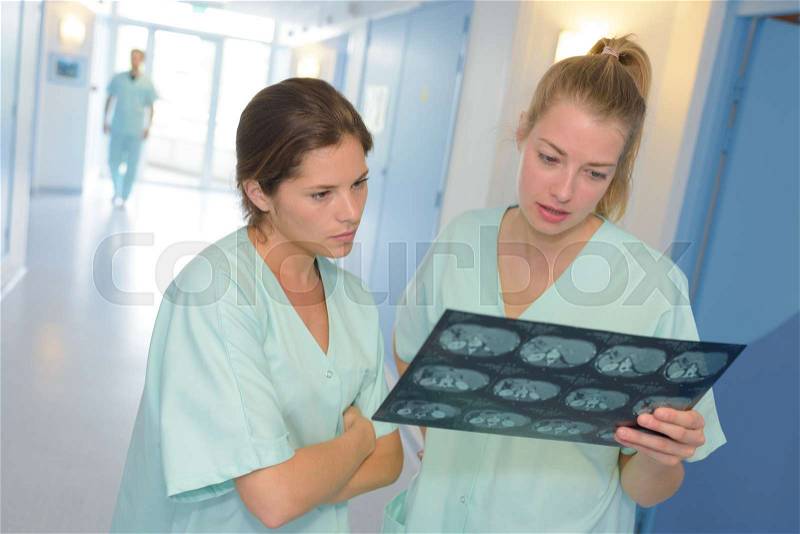 Two students doctors looking at x-ray, stock photo