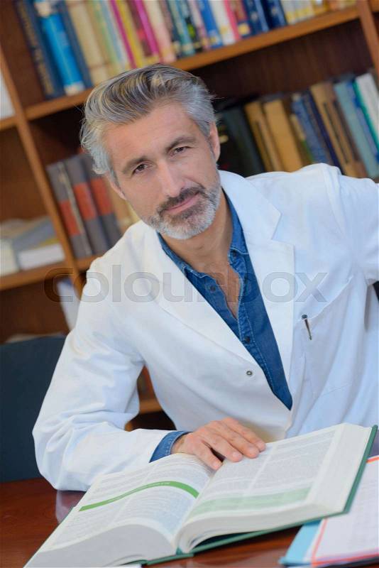 Renowned scientistdoctor in a library of research center, stock photo
