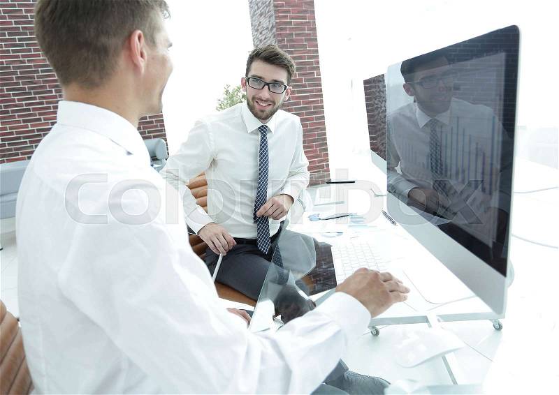 Employees of the company communicate in a modern office, stock photo