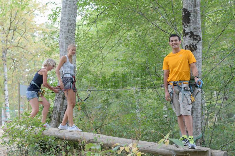 Friends climbing rope at the adventure park, stock photo