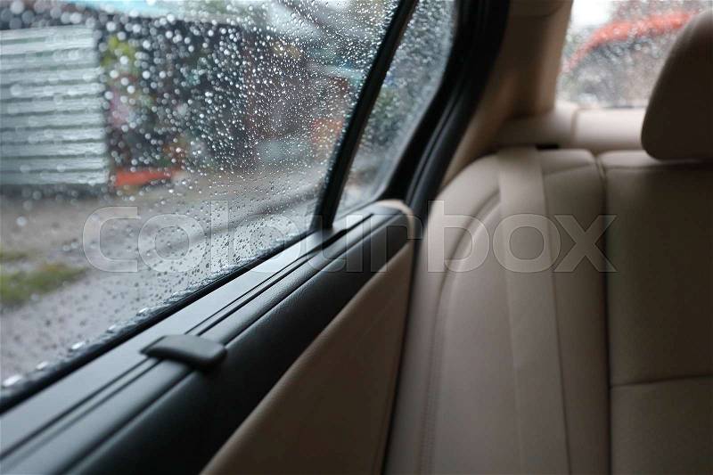 Rain drop on window vehicle car, travel road trips in the rainy day, stock photo
