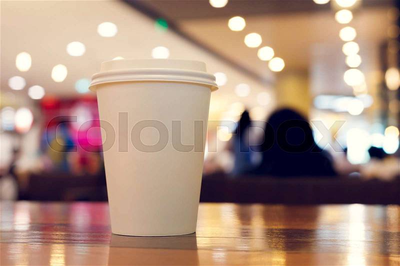 Take away coffee cup empty blank copy space for your design text or banner of brand, hot drink on wood table in cafe shop restaurant with beautiful light decoration party, image used retro vintage filter, stock photo