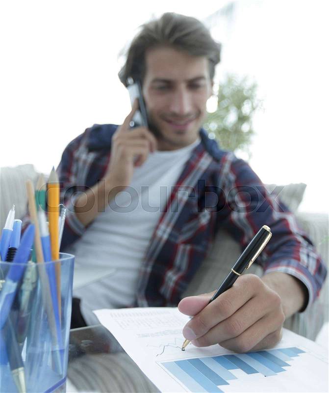 Young man working with financial documents at home .. photo with copy space, stock photo