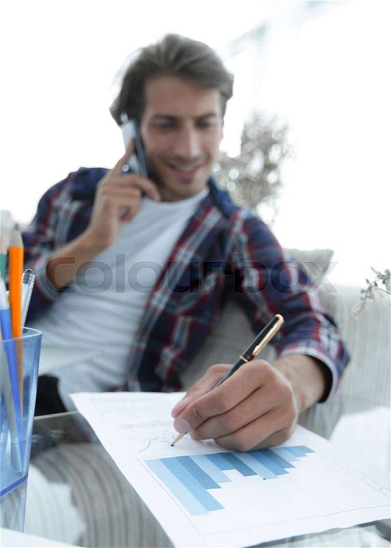 Young man working with financial documents at home .. photo with copy space, stock photo