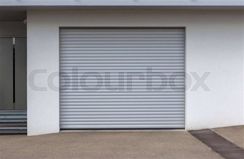 New door of a garage, empty street, stock photo