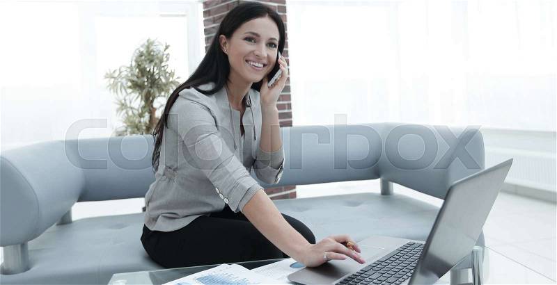 Experienced business woman assistant sitting at the desk. Photo with copy of space, stock photo