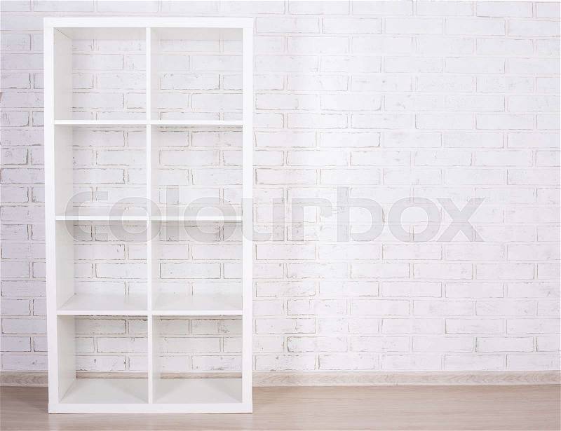 White wooden shelf over white brick wall, stock photo