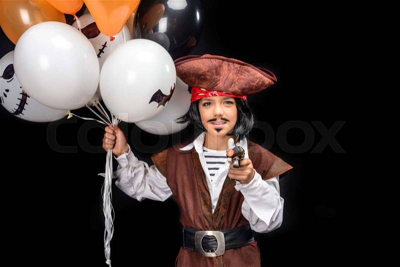 Kid in halloween costume of pirate with gun and balloons, isolated on black , stock photo