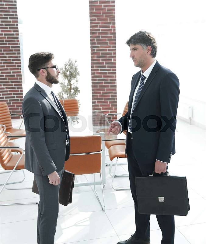Boss and the employee of the company are talking in the office. The photo has a copy of the space, stock photo