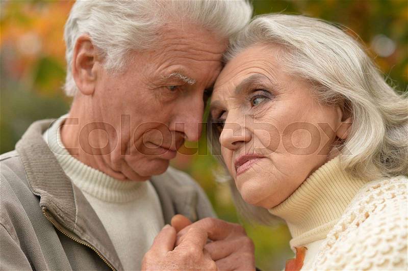 Portrait of a sad senior couple outdoors, stock photo