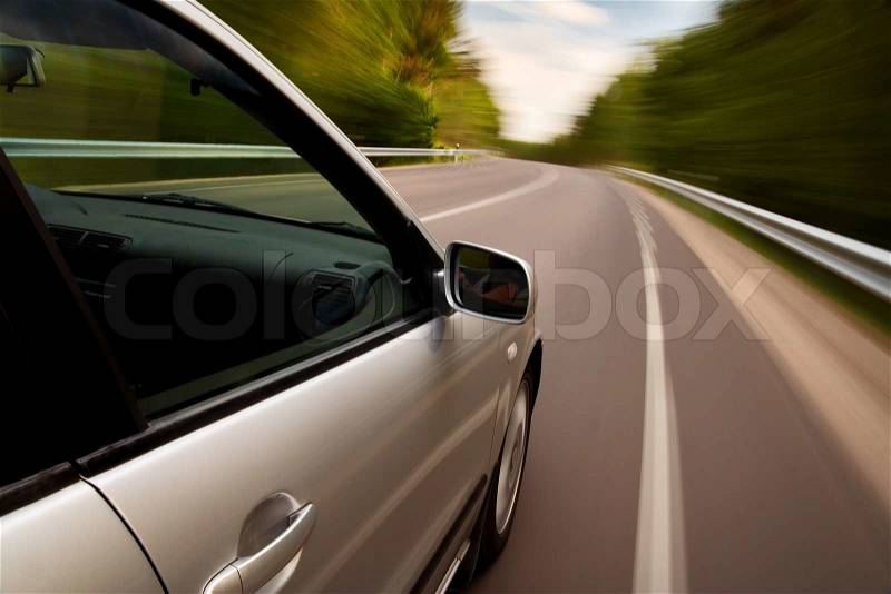 Car driving fast on a country road, stock photo