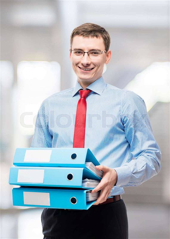 Happy accountant with folders during the reporting period in the office, stock photo