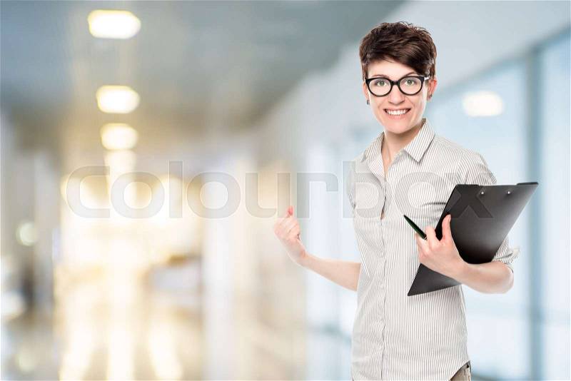 Emotional happy woman with glasses successful in business, portrait in the office, stock photo