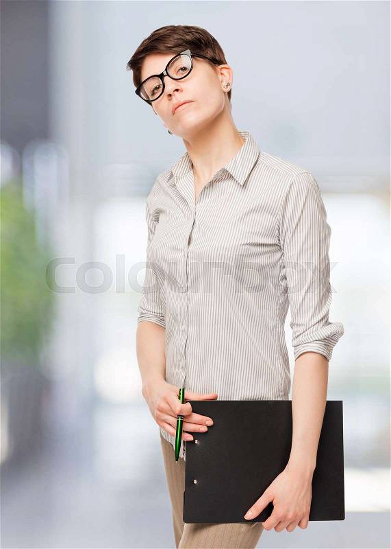 Confident woman in glasses in the office, stock photo