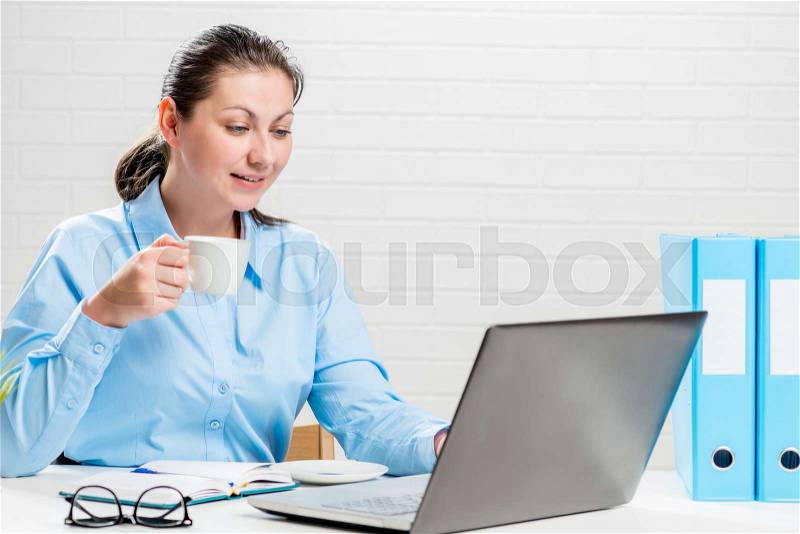 Portrait of a secretary with coffee at work, stock photo