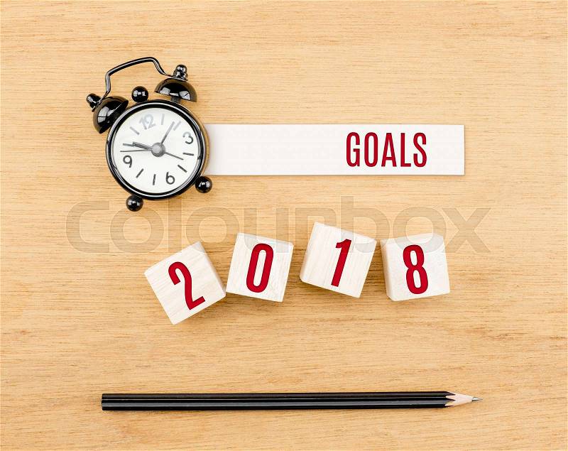 Goals 2018 year red on wood cube with pencil and clock top view on wood table,New year business concept, stock photo