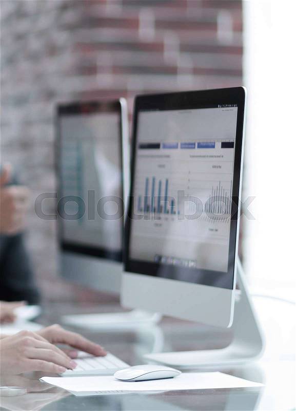 Business team discussing financial charts on a workplace at office, stock photo