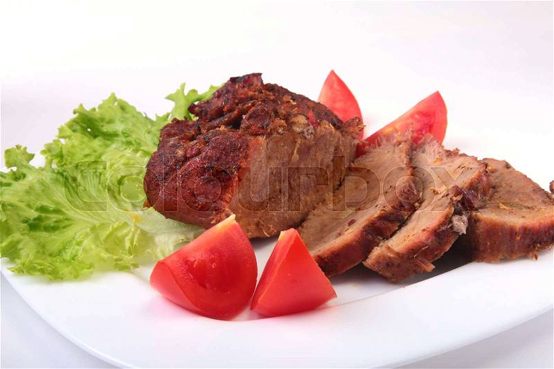 Steak of grilled meat with tomato, lettuce and beans pomegranate on white plate, stock photo