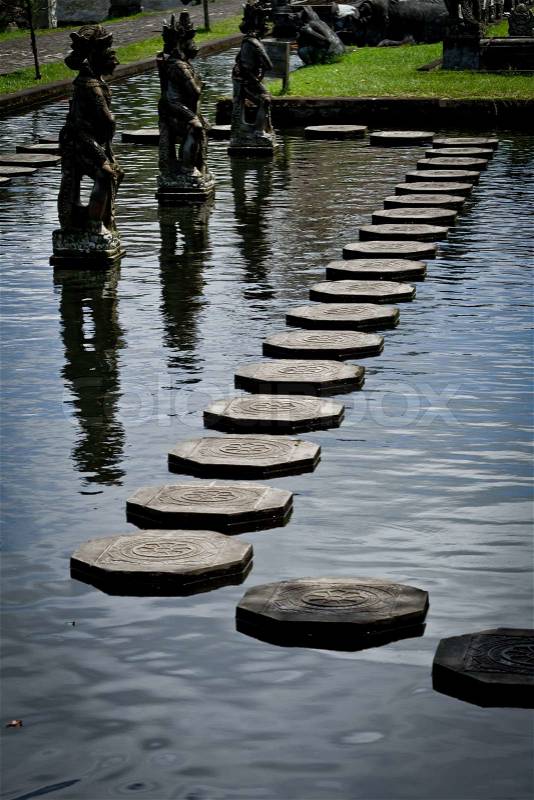Stone steps floating on the water, Tirtagangga water palace, Bali, Indonesia, stock photo