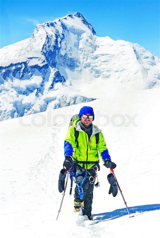 A lonely climber reaching the summit, stock photo