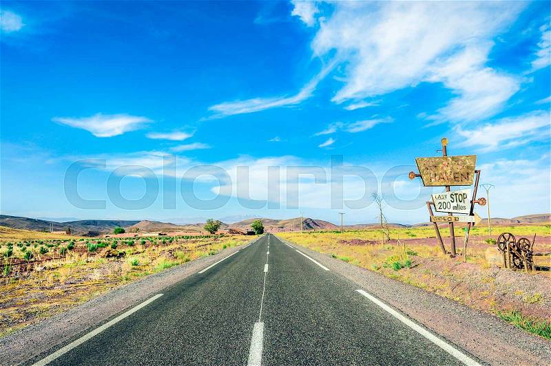 Road in desern. With sign 