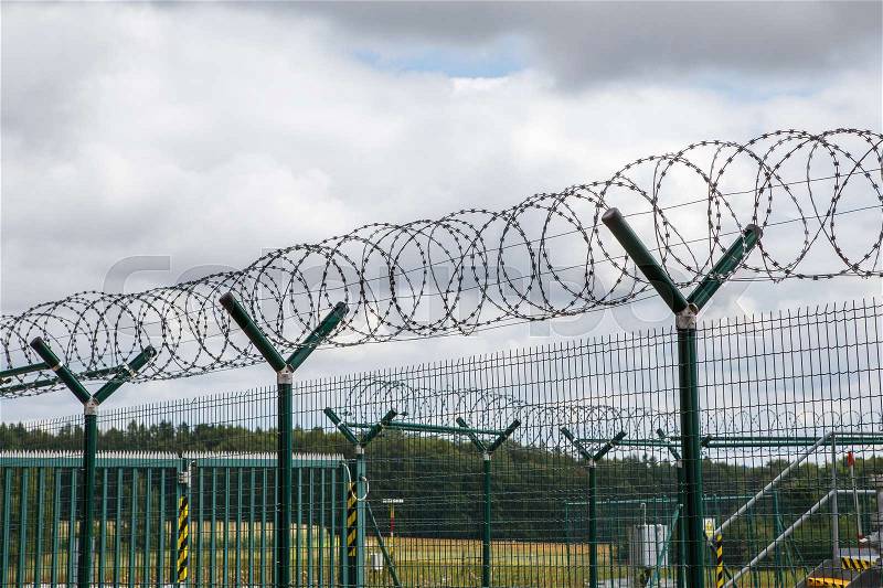 Security fence with a barbed wire. Fence with a barbed wire, stock photo