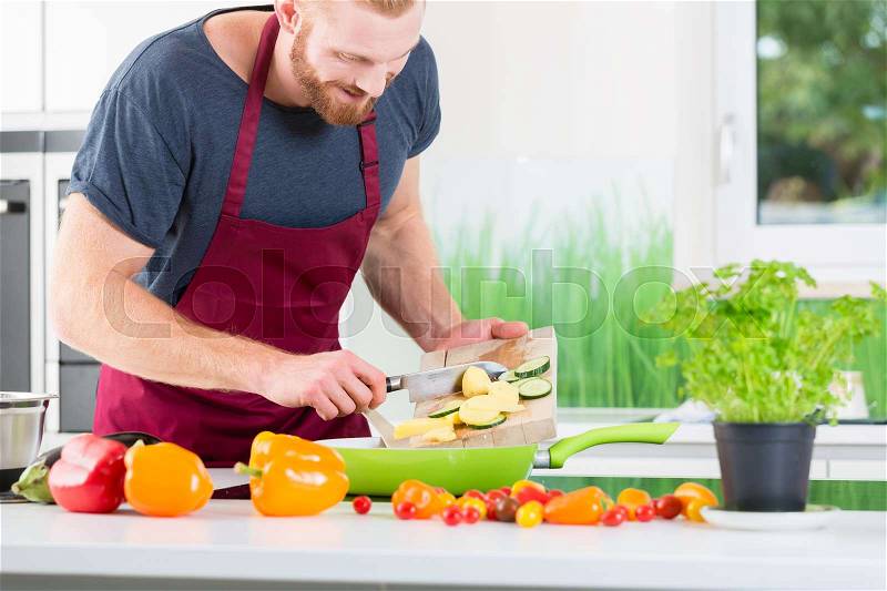Man preparing very healthy organic food for cooking in kitchen, stock photo