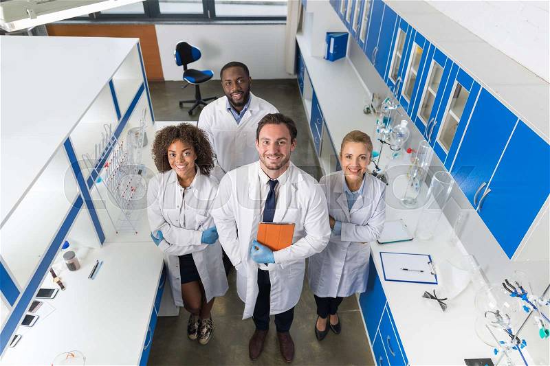 Professor With Mix Race Group Of Scientists In Modern Laboratory Top Angle View Of Smiling Team Of Doctors In Lab Portrait, stock photo